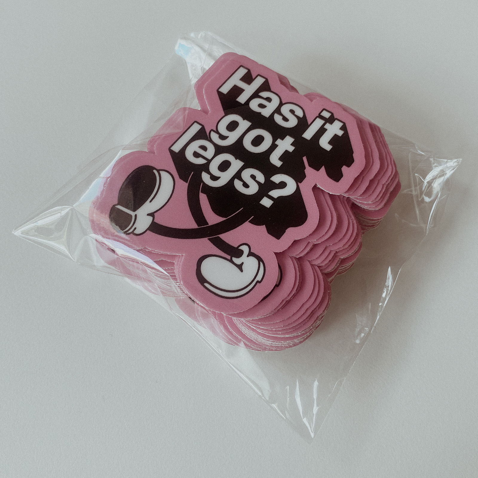 a pile of stickers with the the words ‘has it got legs?’, the words have legs